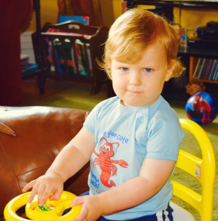Little Ryker with his little baby smurky smurk. Cute kid. But wow, those batteries have to come out of those noisy toys immediately!! 