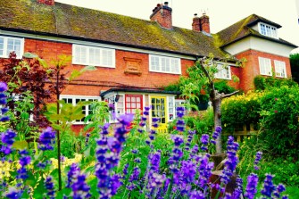 A cute old cottage house, with a lovely English garden.